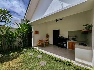 a kitchen and dining area of a house at Soane Summer House by AGATA in Seminyak