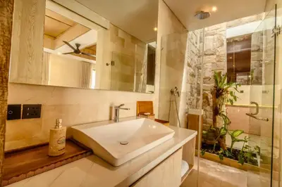 a bathroom with a large sink and a shower at Emica Peaceful Royal 1 BR Pool Villa With Bathtub in Legian