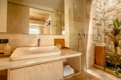 a bathroom with a tub and a sink and a shower at Emica Peaceful Royal 1 BR Pool Villa With Bathtub in Legian