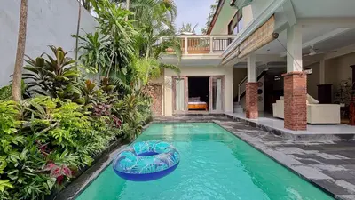 a swimming pool in front of a house at New 2BR Mahaprada Private Pool in Seminyak in Seminyak