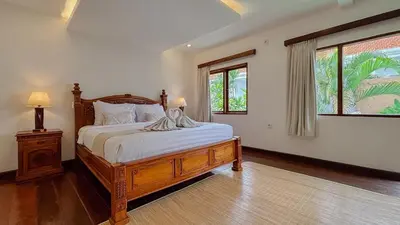 a bedroom with a bed with white sheets and a window at New 2BR Mahaprada Private Pool in Seminyak in Seminyak