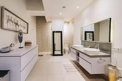 a white bathroom with a sink and a mirror at Modern 2BR Pool Villa in Umalas with Billiard & Long Pool in Canggu
