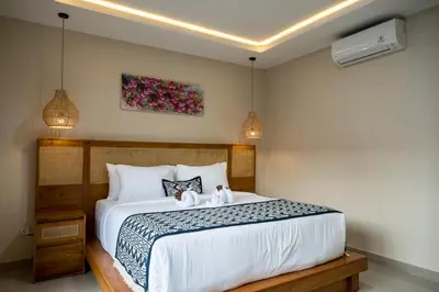 a bedroom with a bed with two stuffed animals on it at Villa Inges 1 Seminyak in Seminyak
