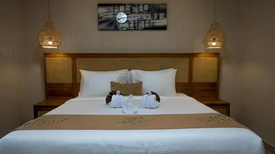 two stuffed animals sitting on top of a bed at Villa Inges 2 Seminyak in Seminyak