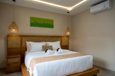 a bedroom with a bed with two stuffed animals on it at Villa Inges 2 Seminyak in Seminyak
