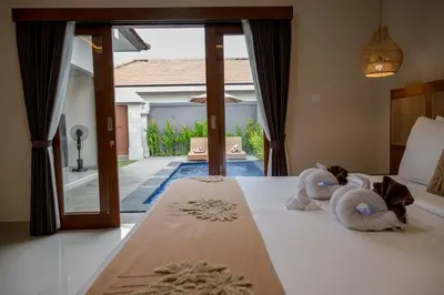 a bedroom with a bed with two stuffed animals on it at Villa Inges 2 Seminyak in Seminyak