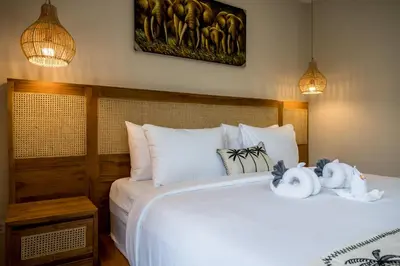 a bedroom with a bed with two stuffed animals on it at Villa Inges 2 Seminyak in Seminyak