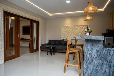 a living room with a couch and a table and chairs at Villa Inges 2 Seminyak in Seminyak