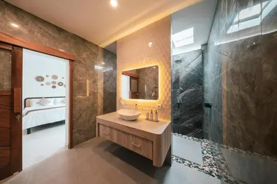 a bathroom with a sink and a shower at Villa Harmaka 2 in Kerobokan