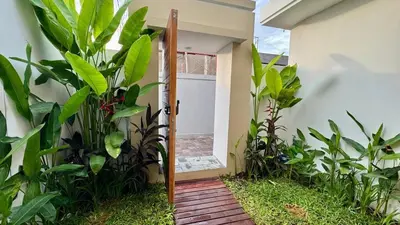 a door leading into a house with plants at Villa Harmaka 2 in Kerobokan