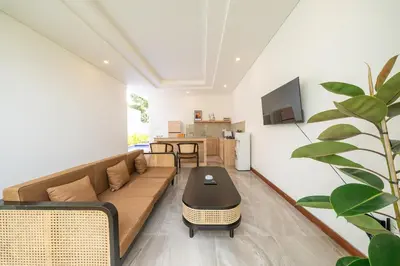 a living room with a couch and a table at Villa Harmaka 2 in Kerobokan