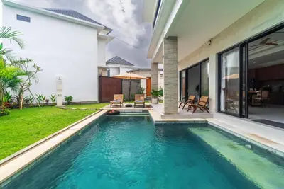 a swimming pool in the backyard of a house at Villa nia gray 1 in Seminyak