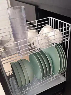a rack of dishes and cups and plates in a refrigerator at Royal villa nusa dua quiet 2BR with public pool in Nusa Dua