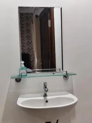 a sink with a mirror and a glass shelf above it at Royal villa nusa dua quiet 2BR with public pool in Nusa Dua