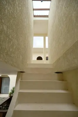 a staircase leading up to a building with a window at Avaya Boutique Hostel by Ayodya Beach Inn in Legian