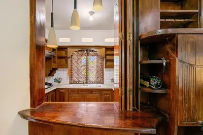 a kitchen with wooden cabinets and a counter top at Private 5BR Jimbaran House with Pool, up to 12 Pax in Jimbaran