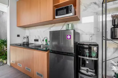 a kitchen with a refrigerator and a microwave at Casa Benita 2 Villa Seminyak in Seminyak