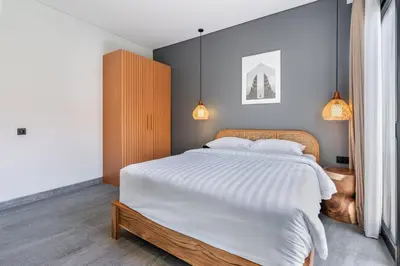 a bedroom with a large bed with white sheets and pillows at Casa Benita 2 Villa Seminyak in Seminyak