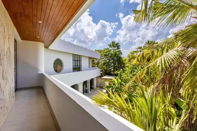 a view from the balcony of a house with palm trees at Ashlyn Elegant 4 BR Private Pool Villa in Canggu