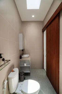 a bathroom with a toilet and a sink at Villa Paoua by BaliSuperHost in Seminyak