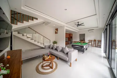 a living room with a couch and a pool table at Villa Amani Seminyak in Seminyak