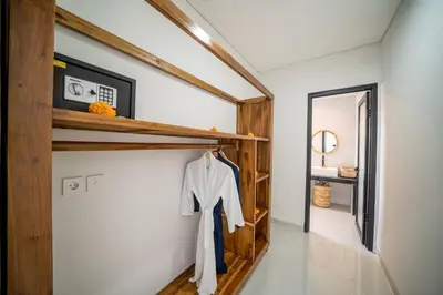 a hallway of a house with wooden shelves at Villa Amani Seminyak in Seminyak