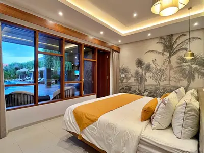 a bedroom with a large bed and a large window at Villa Nishiki 5-Bedroom Private Villa in Seminyak in Seminyak