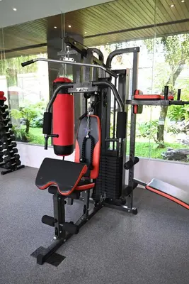 a gym with a red chair in a room at Villa Nishiki 5-Bedroom Private Villa in Seminyak in Seminyak