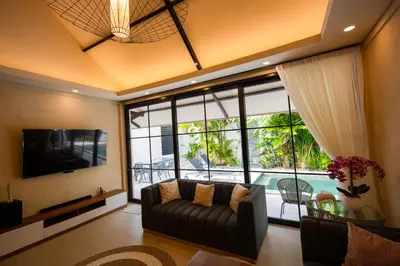 a living room with a couch and a large window at Amazing Private Pool Villa 2BR in Seminyak Bali in Kerobokan