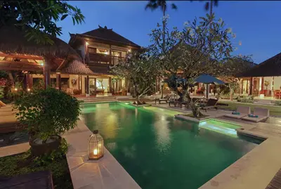 a swimming pool in front of a house at Luxury 6-bedroom Villa in Seminyak in Seminyak