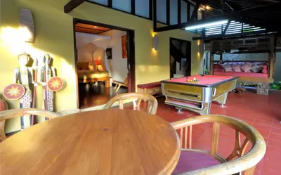 a wooden table with chairs and a ping pong table at Luxury 6-bedroom Villa in Seminyak in Seminyak