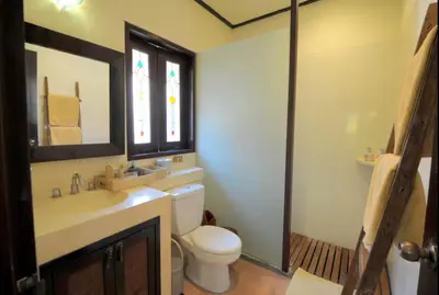 a bathroom with a toilet and a sink and a mirror at Luxury 6-bedroom Villa in Seminyak in Seminyak