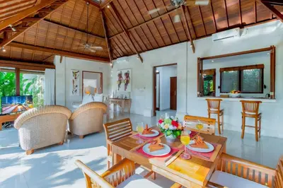 a living room with a table and chairs at Heart of Seminyak, 2Br, Sleeps 4, Walk to Bintang in Seminyak