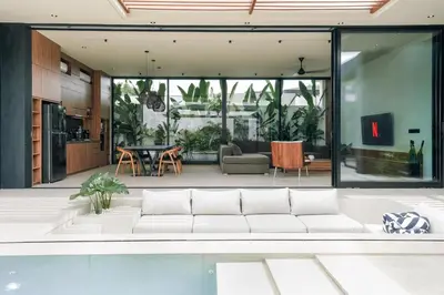a living room with a white couch in a house at Villa Dorithis Umalas in Kerobokan