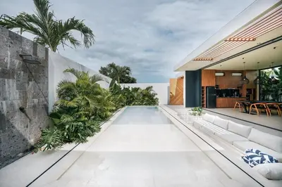 a swimming pool in the backyard of a house at Villa Dorithis Umalas in Kerobokan