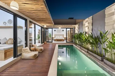 a house with a swimming pool and a living room at Nara V3 2BR Escape in the Heart of Seminyak in Seminyak
