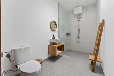 a bathroom with a toilet and a sink and a shower at Nara V3 2BR Escape in the Heart of Seminyak in Seminyak