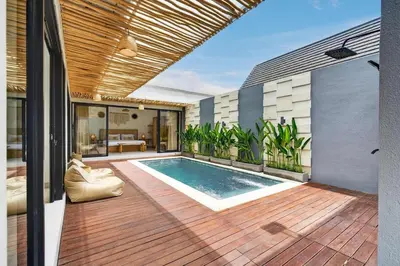 a house with a swimming pool on a wooden deck at Nara V3 2BR Escape in the Heart of Seminyak in Seminyak