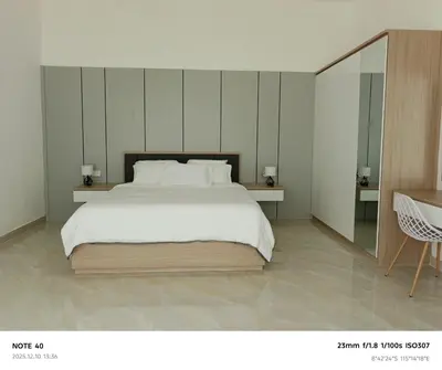 a bedroom with a large bed and a mirror at Khrisna Sanur Villa in Pesanggaran