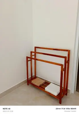 a wooden shelf in the corner of a room at Khrisna Sanur Villa in Pesanggaran