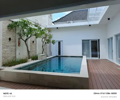 a swimming pool in the middle of a house at Khrisna Sanur Villa in Pesanggaran