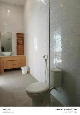 a bathroom with a toilet and a sink at Khrisna Sanur Villa in Pesanggaran
