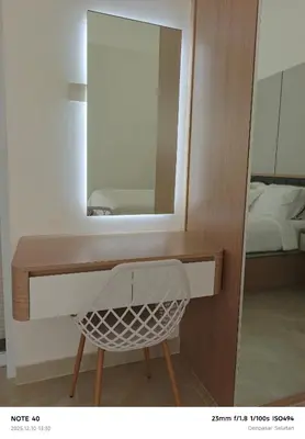 a bathroom with a mirror and a basket on a counter at Khrisna Sanur Villa in Pesanggaran