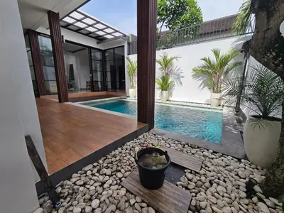 an external view of a house with a swimming pool at Vila Hokyusa in Kerobokan