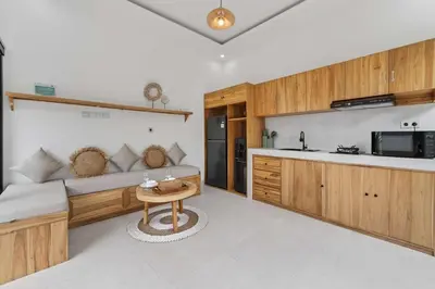 a kitchen and living room with a couch and a table at Nara V11 2BR Escape in the Heart of Seminyak in Seminyak