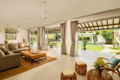 a living room with a couch and a table at Dulcinea Spacious 5 BR Private Pool Villa in Jimbaran