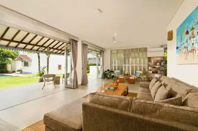 a living room with a couch and a table at Dulcinea Spacious 5 BR Private Pool Villa in Jimbaran