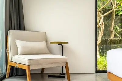 a chair and a lamp in a room at Villa Semilir Pagi, Canggu in Canggu