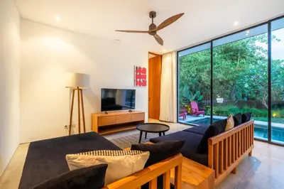 a living room with a couch and a tv at Villa Semilir Pagi, Canggu in Canggu