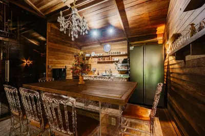 a dining room with a large wooden table and chairs at Wow Cozy Lagoon! in Nusa Dua